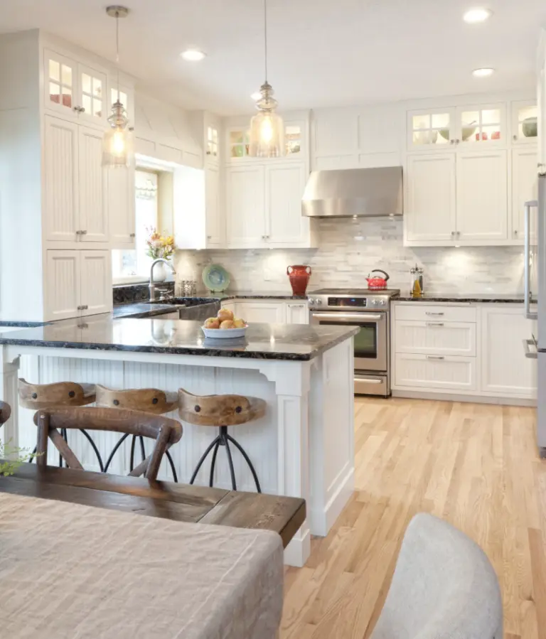 White shaker kitchen with an island and hardwood floors