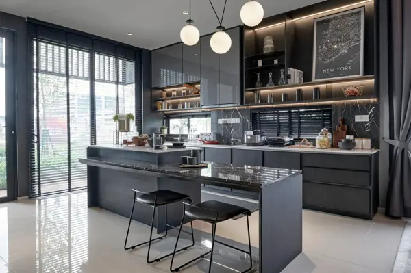 Remodeled kitchen with dark cabinetry, island seating, and pendant lights