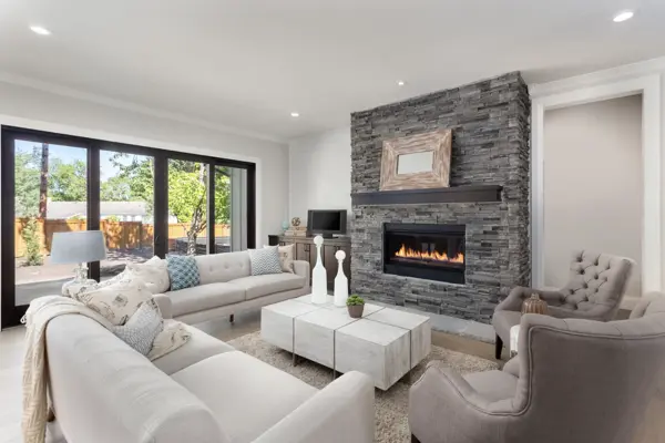 Bright living room with a stacked-stone fireplace