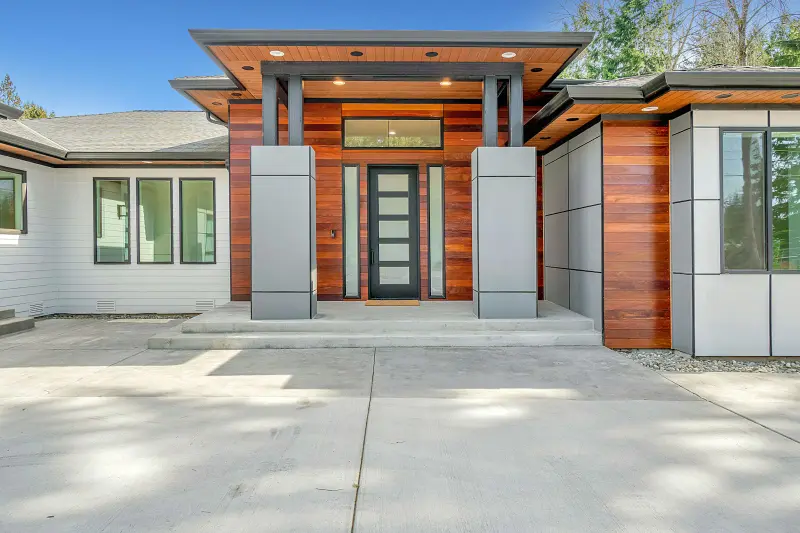 Contemporary home entry with wood and stone accents